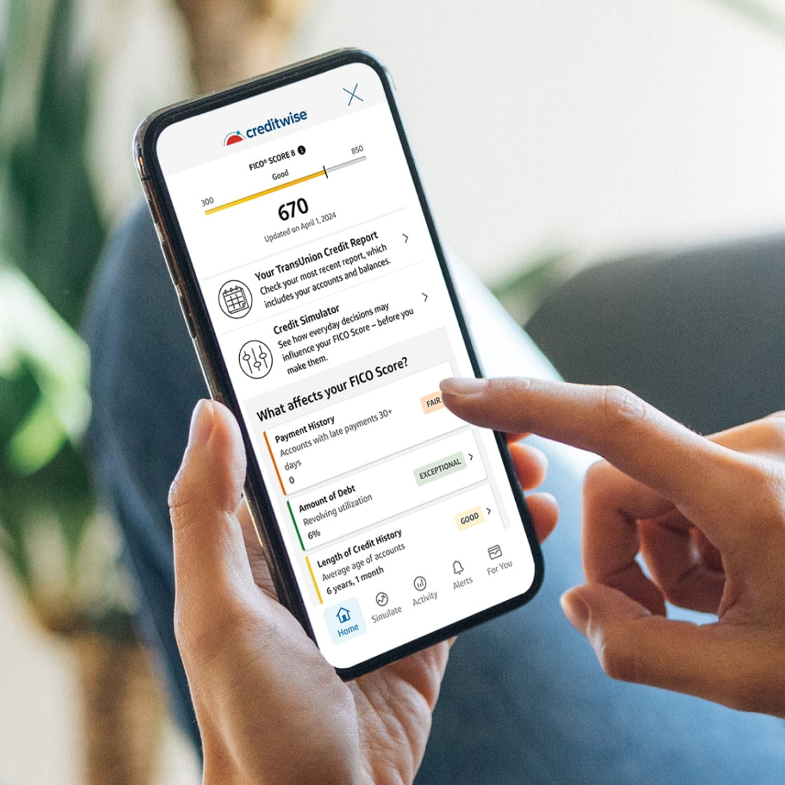 Scrolling through the CreditWise app on a phone
